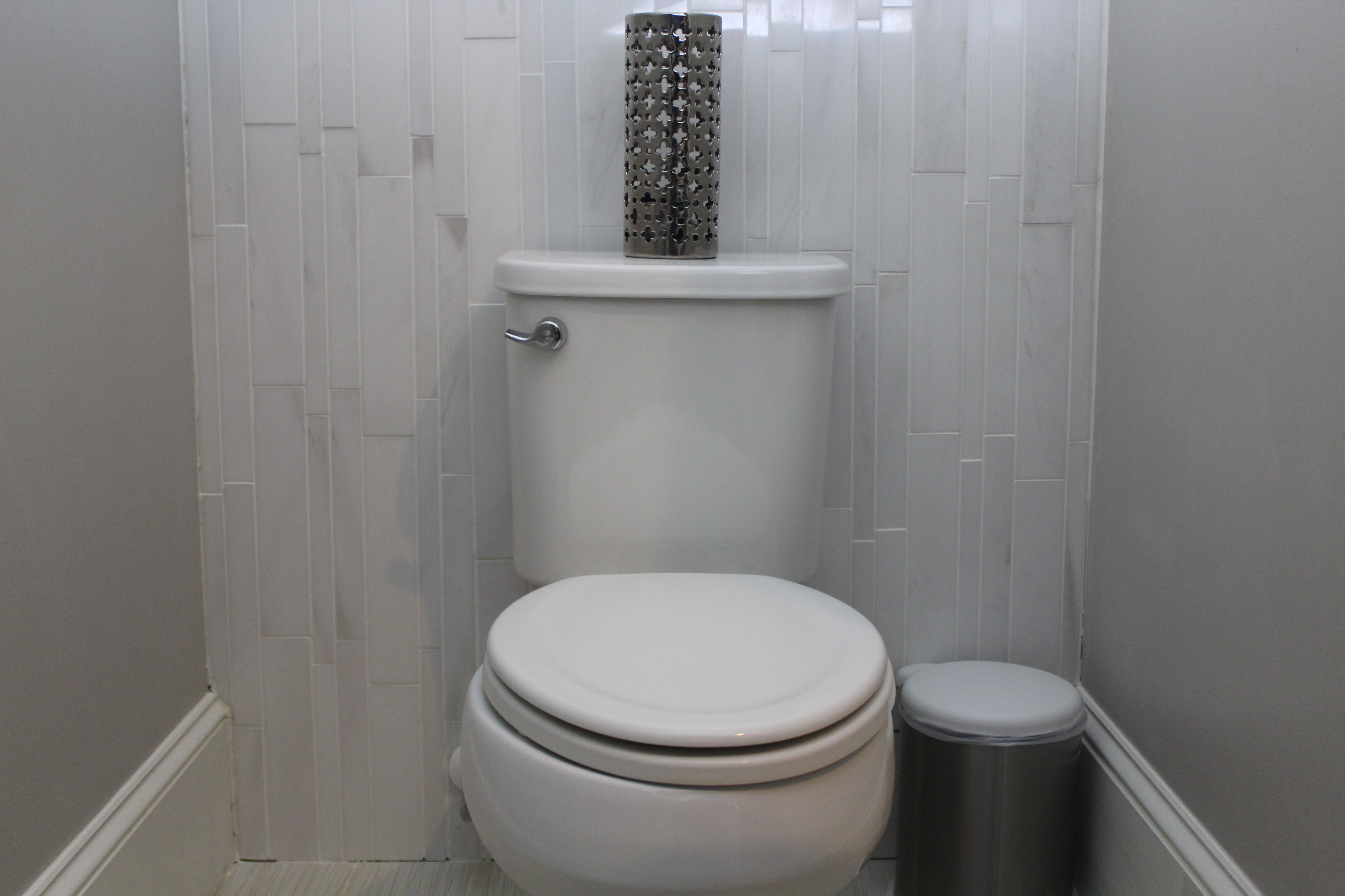 Norstone White Marble Lynia Tile Installed on a feature wall behind the toilet in a powder bath